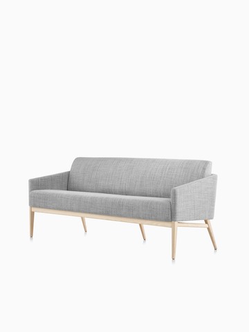 Three-quarter view of gray Palisade Sofa with wood legs.