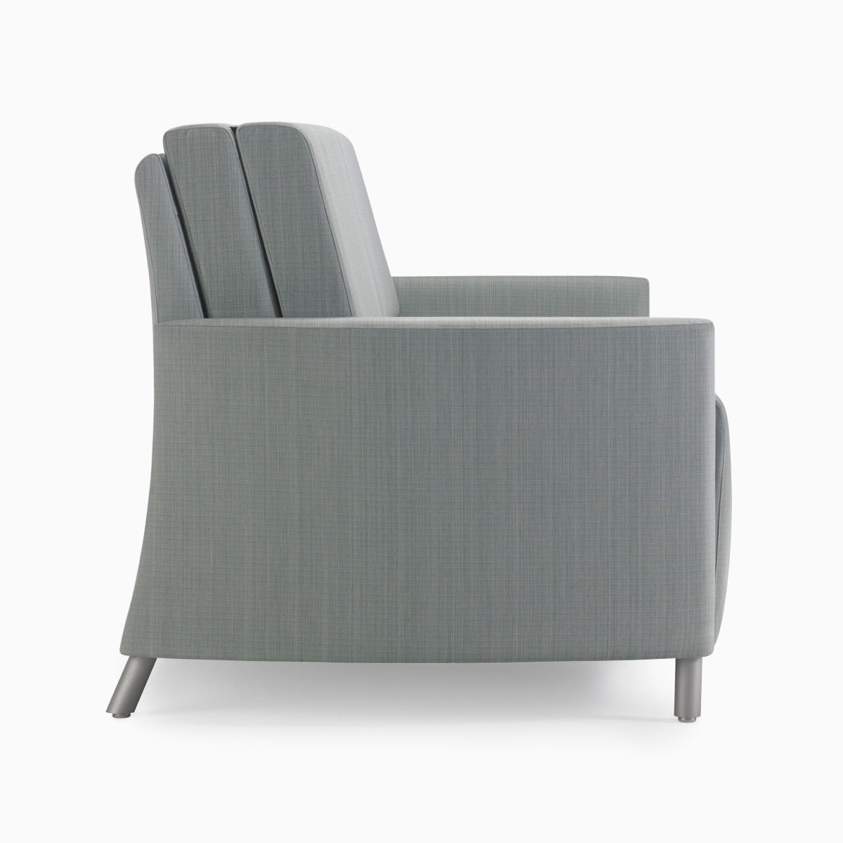 Side view of a Nemschoff Pamona Flop Sofa in gray textile with wall-saver metal legs.