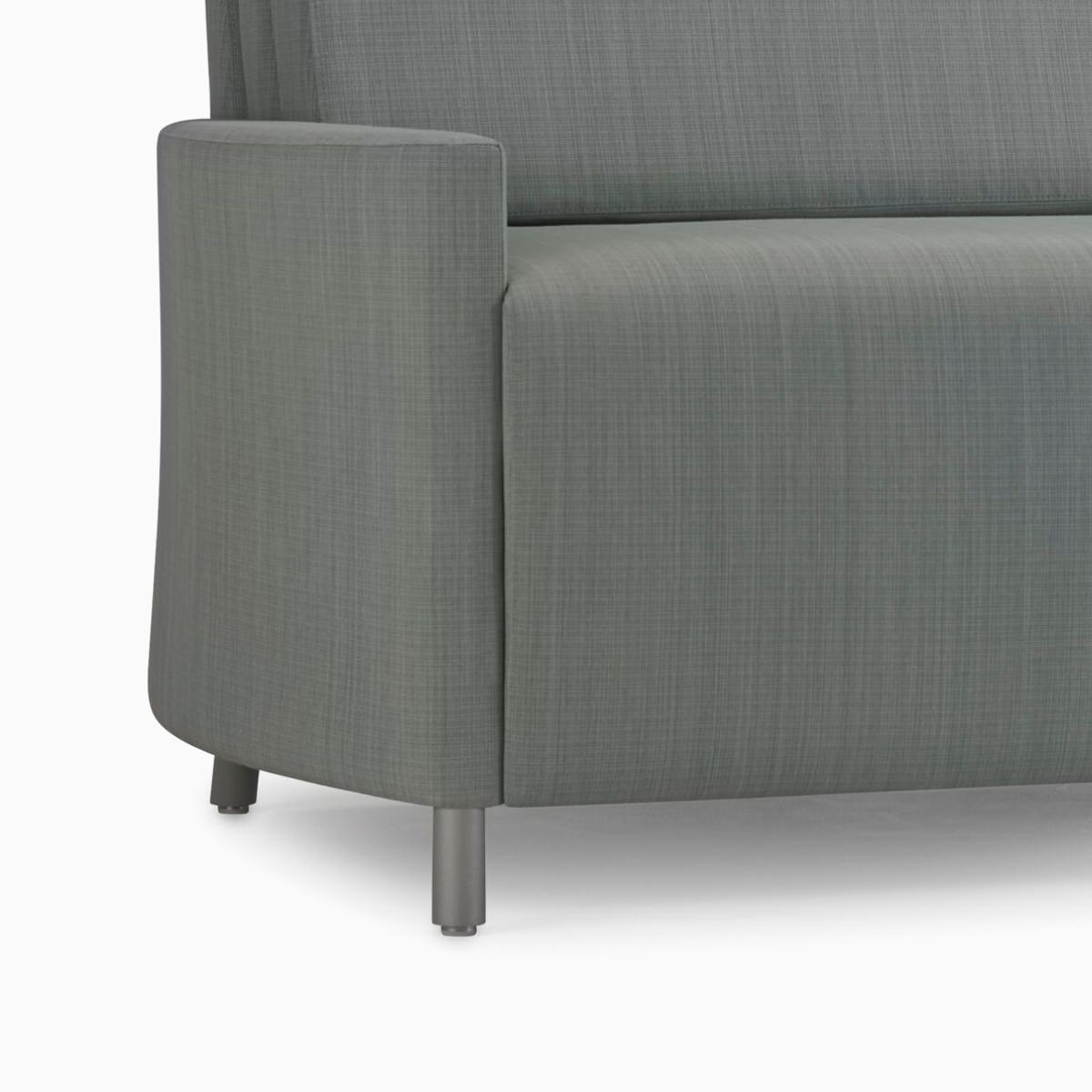 An angled view of a Nemschoff Pamona Flop Sofa in gray textile with metal legs.
