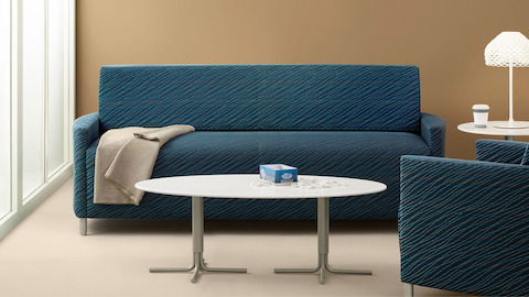 Nemschoff Pamona Flop Sofa in a medium blue patterned upholstery in a grouping of an armchair, coffee table, and side table.
