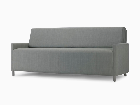 An angled view of a Nemschoff Pamona Flop Sofa in a gray textile with metal legs.