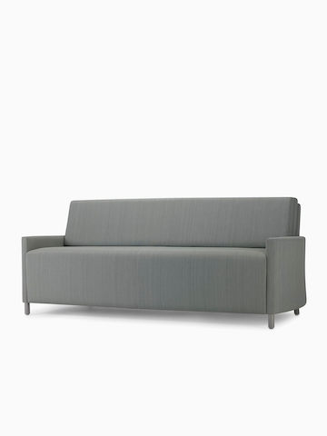 An angled view of a Nemschoff Pamona Flop Sofa in gray textile with metal legs. Select to go to the Nemschoff Pamona Flop Sofa product page.