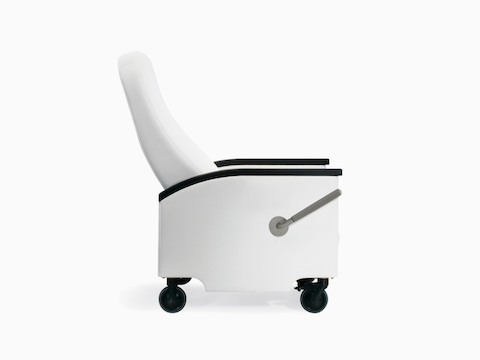 A side view of a Prísto Plus Recliner in a white upholstery with black urethane arm caps in a slightly reclined position.