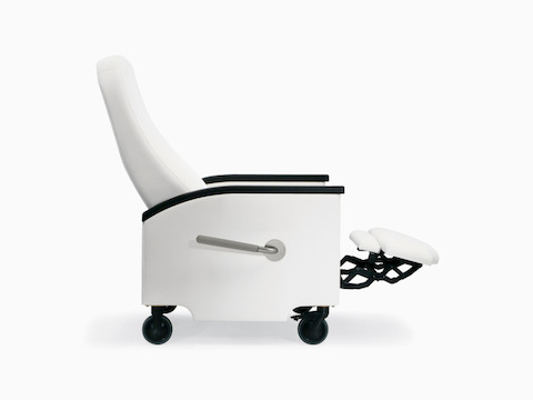 A side view of a Prísto Plus Recliner in a white upholstery with black urethane arm caps in a slightly reclined position with the footrest up.