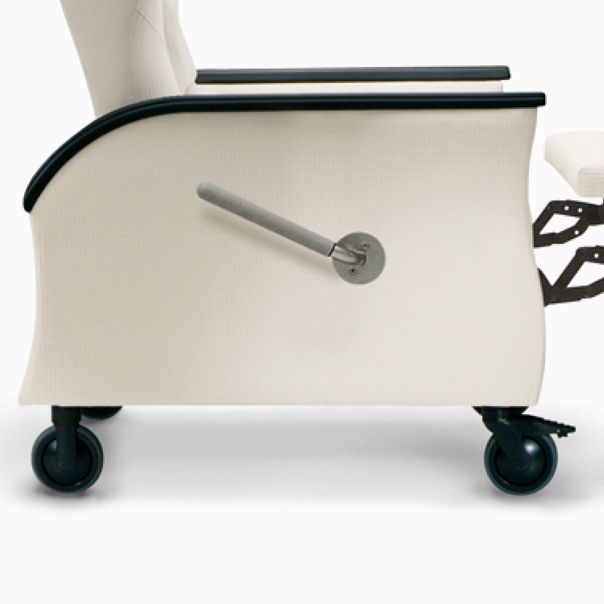 Close-up of a swiveling front caster with brake and a rear fixed caster on a Nemschoff Pristo Recliner.