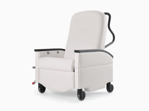 Three-quarter view of a Nemschoff Pristo Recliner in a white upholstery with black arm caps and wheels. Three-quarter view of a Nemschoff Pristo Recliner in a white upholstery with black arm caps and wheels.