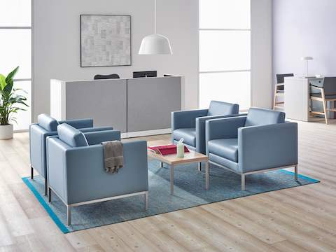 A well-lit waiting room featuring Riva lounge chairs in blue textile with brushed metal legs and Monarch Easy Access Chairs.