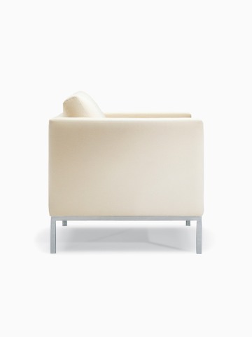 A Riva Armchair in light textile with brushed metal legs, viewed from the side.