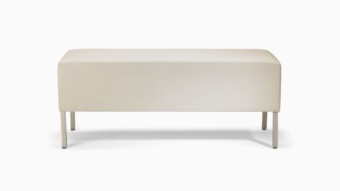 A Riva lounge bench in a light-colored textile with brushed metal legs.
