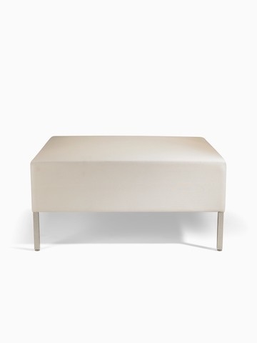 A Riva ottoman bench in light-colored textile with brushed metal legs.