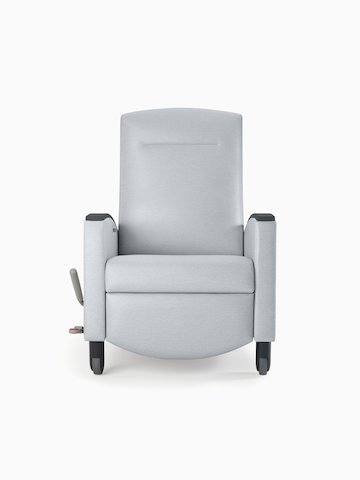 Nemschoff Sahara Recliner in a light gray upholstery and black arm caps and casters on white sweep, viewed from the front.