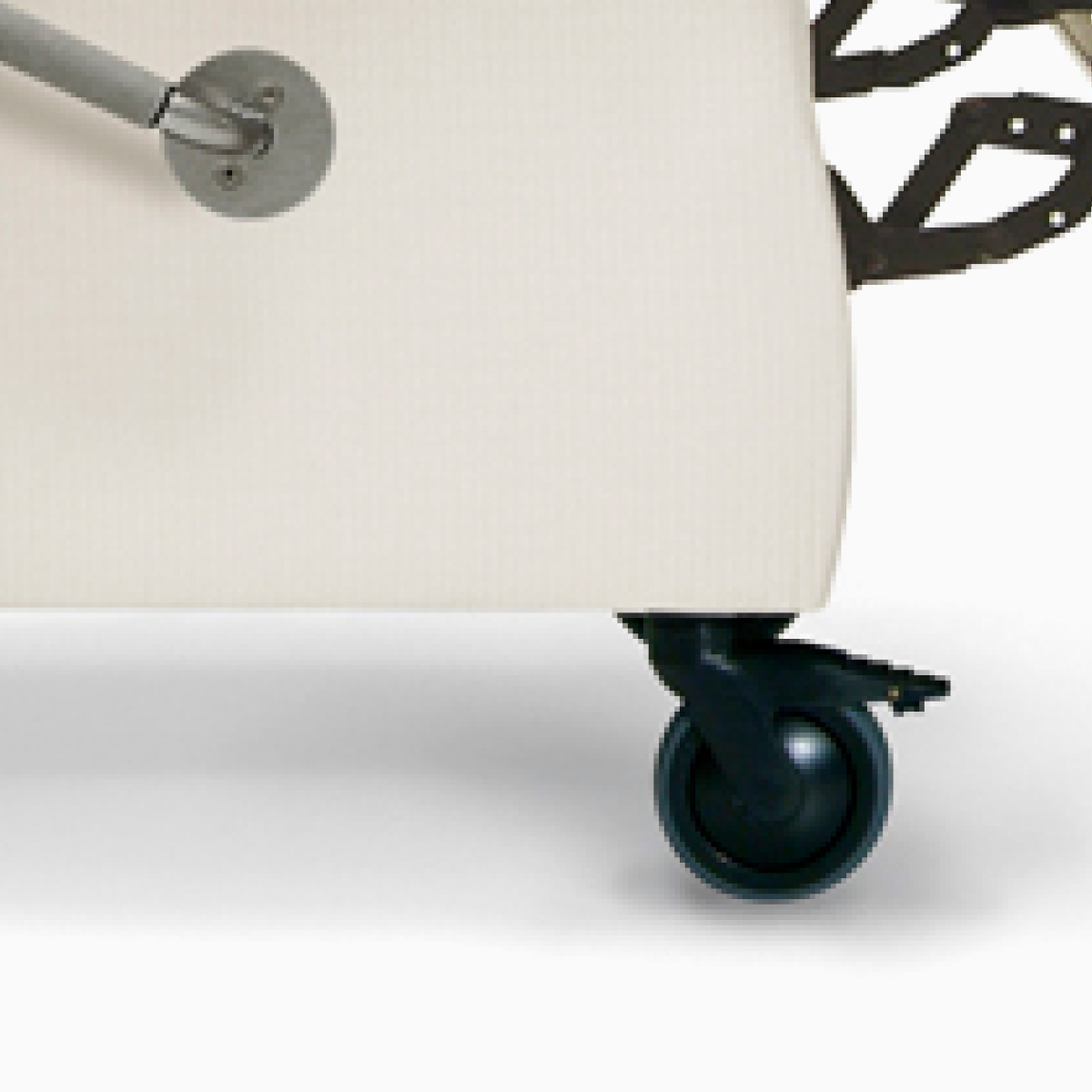 Close-up of a swiveling front caster with brake on a Nemschoff Serenity Recliner.