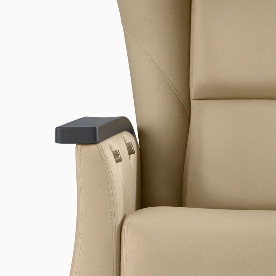 Close-up of a Nemschoff Serenity Recliner showing the dual activation buttons on the inside of the arm.