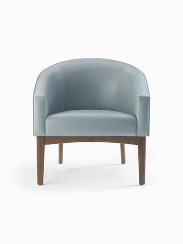 A Sophora Lounge Chair in light blue textile with walnut legs and base.