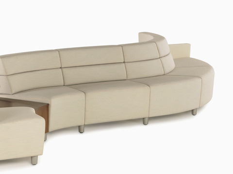 A low-back Nemschoff Steps Lounge System in a curved configuration in a light-colored textile.