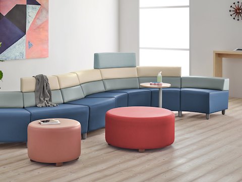 A waiting area with a Steps Lounge System and Steps Ottoman in brightly colored textiles.