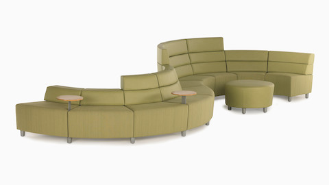 A Steps Lounge System in a curved configuration upholstered in green textile.
