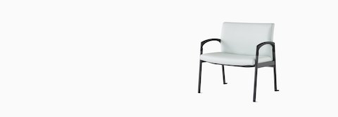 Three-quarter view of a Valor Plus Chair in a light gray upholstery and black frame. Three-quarter view of a Valor Plus Chair in a light gray upholstery and black frame.