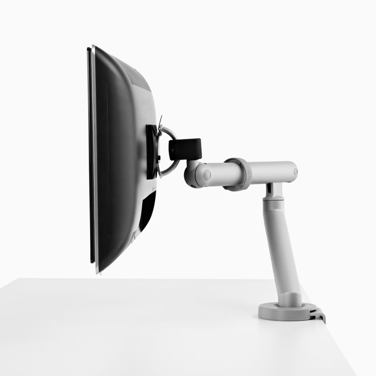 A computer monitor supported by a silver Flo Monitor Arm.