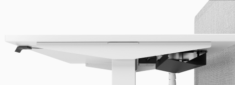 A close-up view of a Nevi Link standing desk system with white 120-degree work surfaces, white legs, and light blue screens. One of the three desks is raised to standing height.