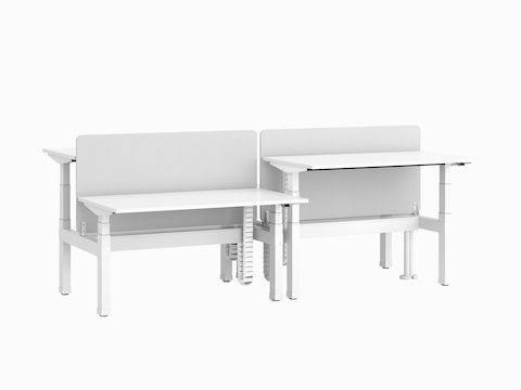 Nevi Link Sit-Stand back-to-back four-desk configuration in white with grey fabric screens and two desks raised to standing height.