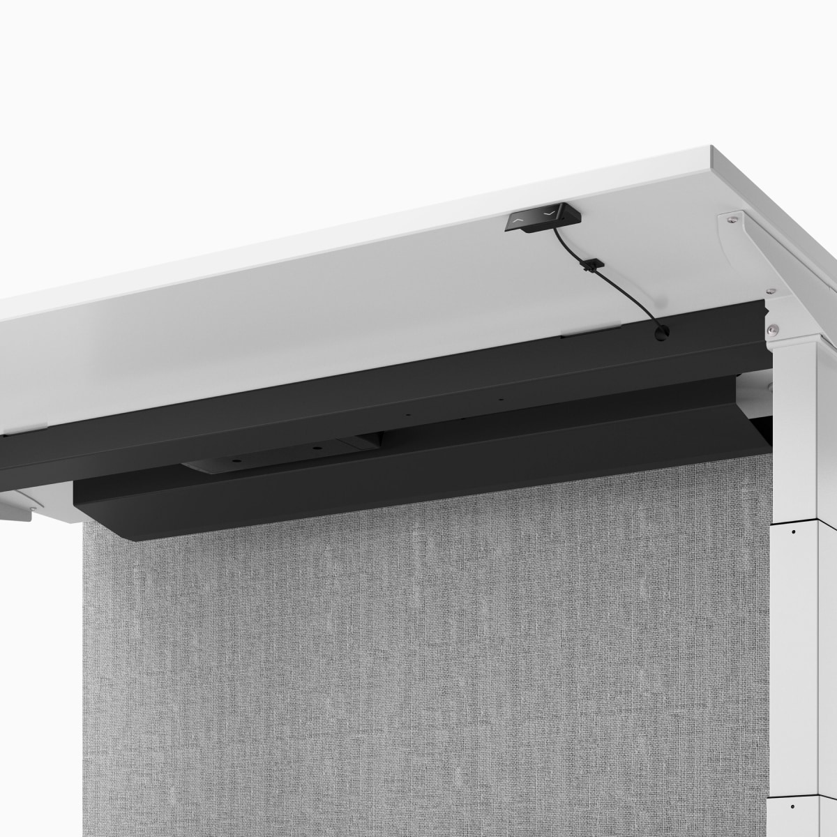 A close-up view of underneath a white Nevi Link desk raised to standing height and showing the upper cable tray and grey fabric screen.