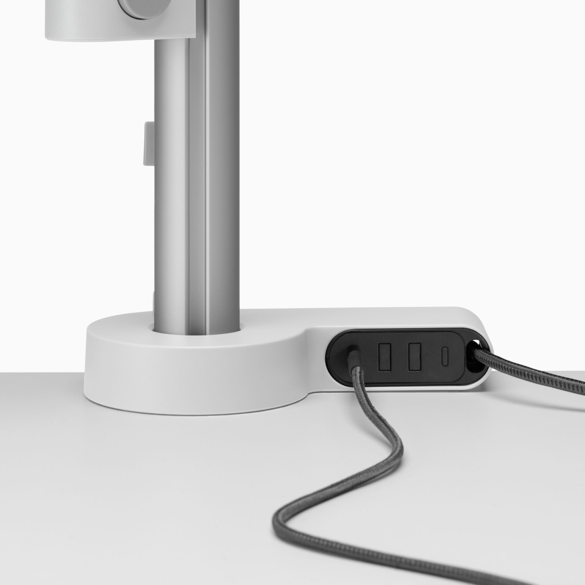 A desk with a power and data cable connected to an Ondo Connectivity Module.