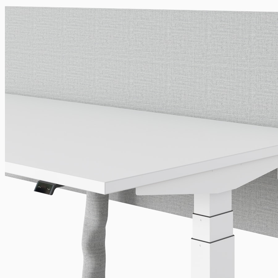 A white Nevi Sit-Stand Desk with fabric umbilical.