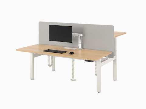 Nevi Sit-to-Stand Desks in a back-to-back two-desk configuration in white, with a light coloured work surface, a fabric screen and a floor umbilical.