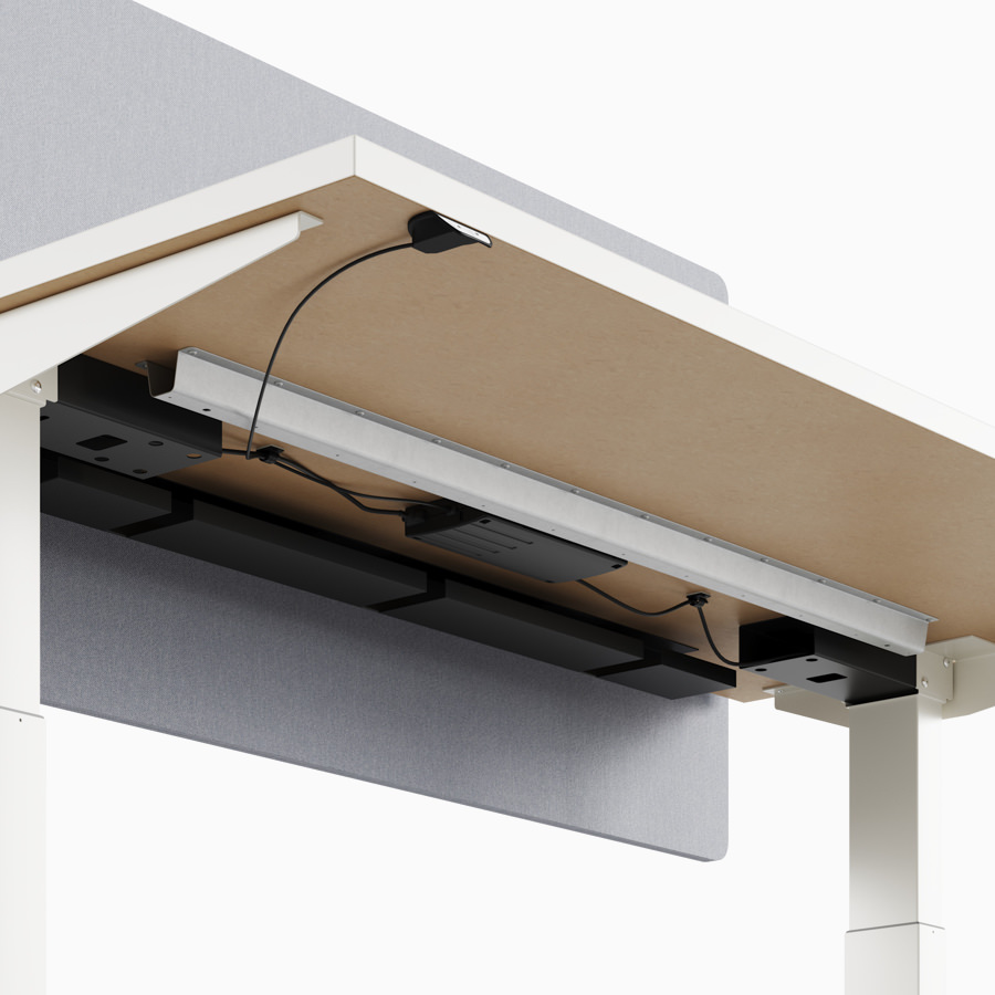 A close-up view of Nevi standing desk's under-surface cable channel.