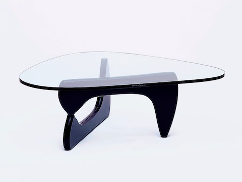 A Noguchi occasional table, showing Isamu Naguchi's signature on the edge of the glass top. A Noguchi occasional table, showing Isamu Naguchi's signature on the edge of the glass top.