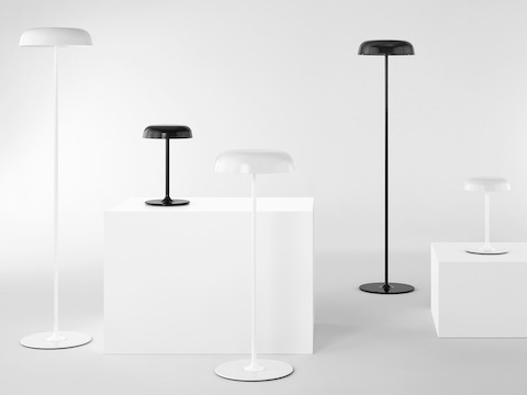 Three white and two black Ode Lamps, including table, sofa, and standing-height floor models.