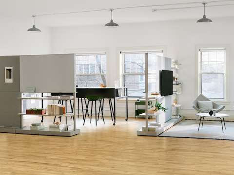 Grey OE1 Agile Walls with green Striad Sofa and checkerboard Nelson Coconut Chair in the foreground, with black OE1 Communal Table in the background.