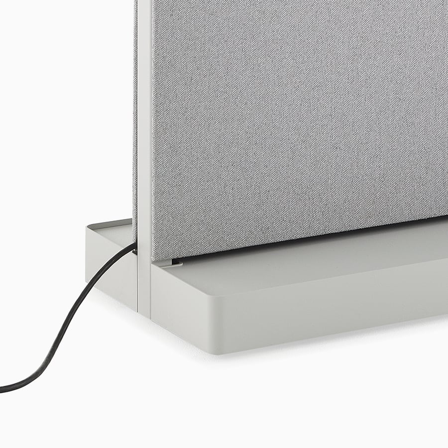 Close-up image of a grey, fully cladded OE1 Agile Wall with a power cable coming out of the base, viewed from an angle.