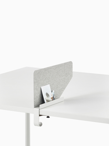 Grey OE1 Boundary Screen with liner on a white OE1 Rectangular Table, viewed from an angle.