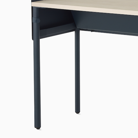 Dark blue, single sided OE1 Communal Table with light brown surface, viewed from an angle.