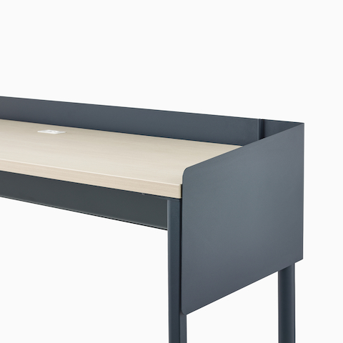 A dark blue OE1 Communal Table with light brown surface and dark blue metal screen, viewed from a front angle.