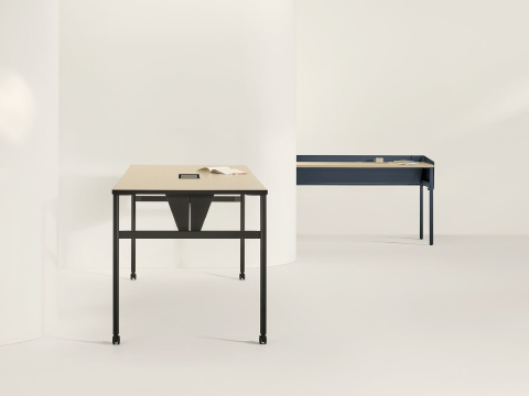 Two OE1 Communal Tables with light brown surfaces and black and blue finishes, viewed from side and front angles.