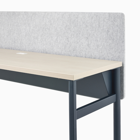 A dark blue OE1 Communal Table with light brown surface and grey fabric screen, viewed from a front angle.