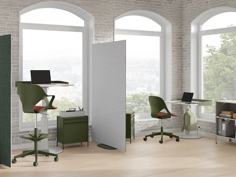 Bright office with green and grey OE1 Curved Screens, green OE1 Storage Trolleys, green Zeph Chair and OE1 Sit-to-Stand Tables.