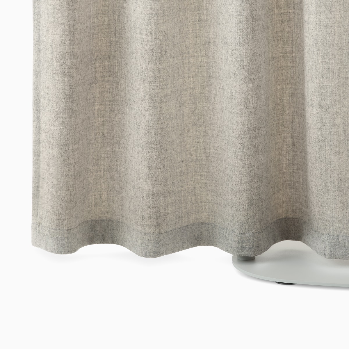 Detail of a light brown OE1 Freestanding Curtain with a grey base.