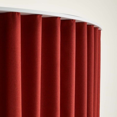 Detail of a red OE1 Freestanding Curtain, viewed from a front angle.