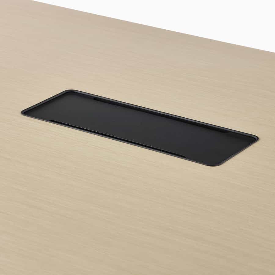 Close up image of a light brown OE1 Huddle Table with black closed technology bucket.