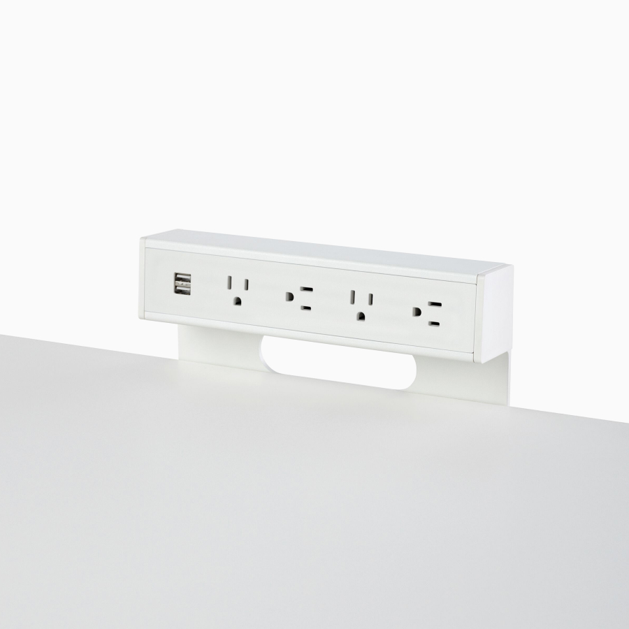 A surface-mounted Logic C1000 power port with four power outlets and two USB connections.