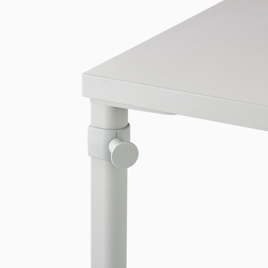 Close up image of a white OE1 table with white bag hook, viewed from a front angle.