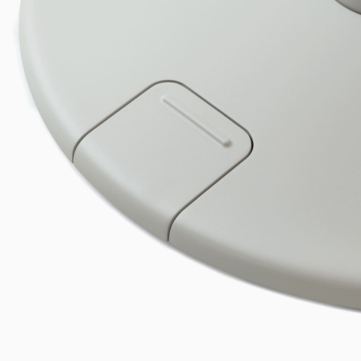 Detail of a grey OE1 Sit-to-Stand Table base with foot-controlled up/down pedal, viewed from an angle.