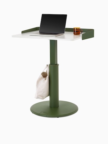 OE1 Sit-to-Stand Table with green base and white surface with green wrap screen at a standing height, viewed from a front angle.