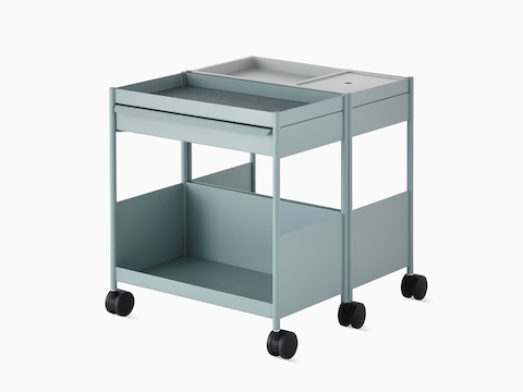 Light blue OE1 Storage Trolley with casters in a dual-mobile configuration, viewed from an angle.