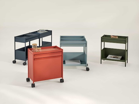 Dark blue, light blue, red and green OE1 Storage Trolleys in various configurations, including casters and glides.