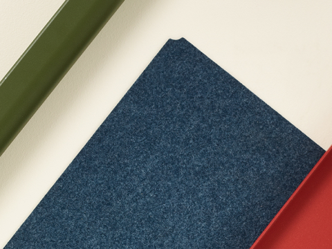 A selection of OE1 Workspace Collection materials, including light brown laminate surface, grey marker cup, green leg, blue fabric and red frame. A selection of OE1 Workspace Collection materials, including light brown laminate surface, grey marker cup, green leg, blue fabric and red frame.
